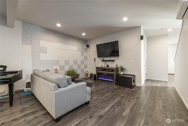 living room with dark hardwood / wood-style floors and a wall mounted air conditioner