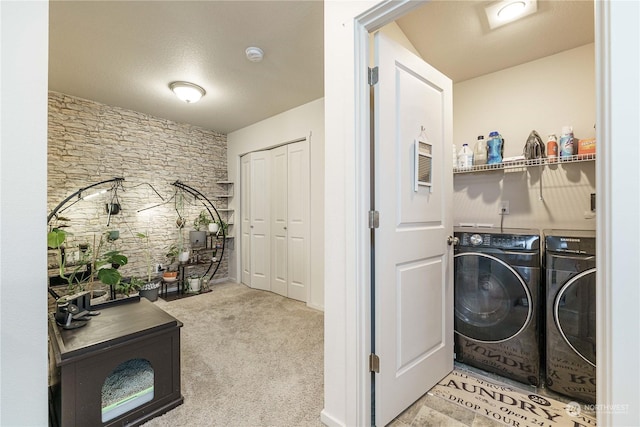 laundry area featuring light colored carpet and separate washer and dryer