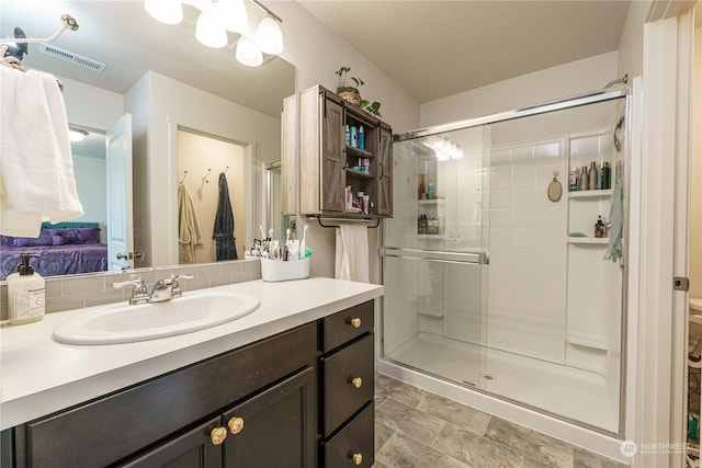 bathroom with an enclosed shower and vanity