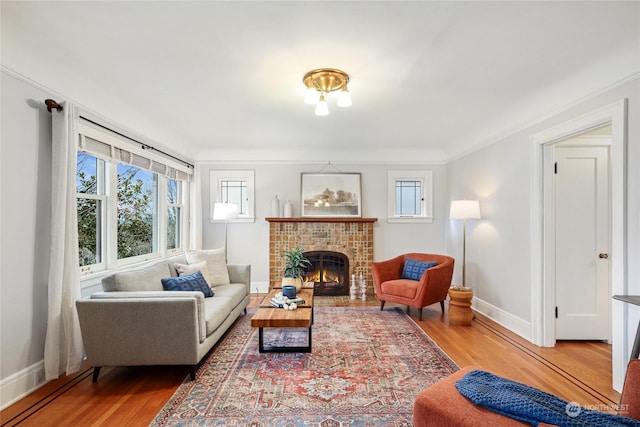 living room featuring ornamental molding, a fireplace, and hardwood / wood-style flooring