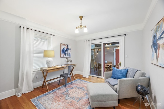 office space with hardwood / wood-style floors, an inviting chandelier, and crown molding