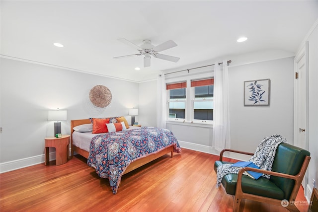 bedroom featuring ceiling fan, crown molding, and wood-type flooring