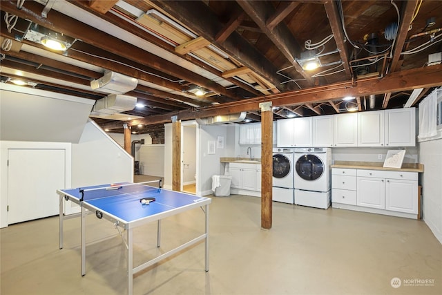 basement with separate washer and dryer and sink