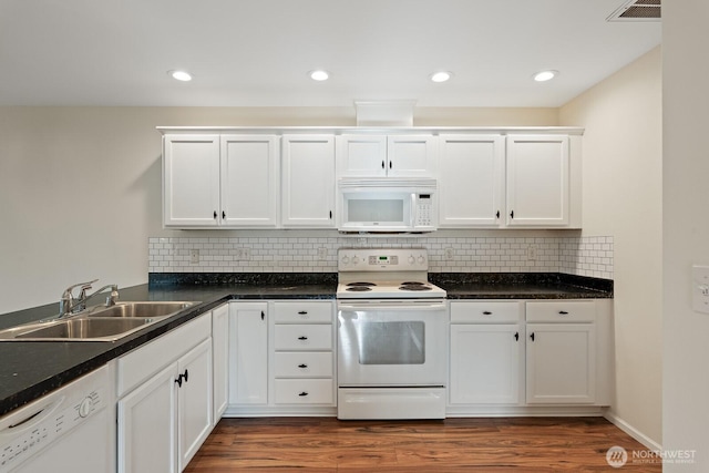 kitchen featuring white cabinets, tasteful backsplash, a sink, and white appliances