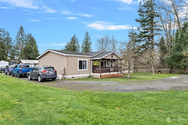 view of front of home featuring covered porch and a front yard