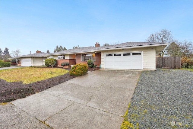 single story home with a garage and a front yard