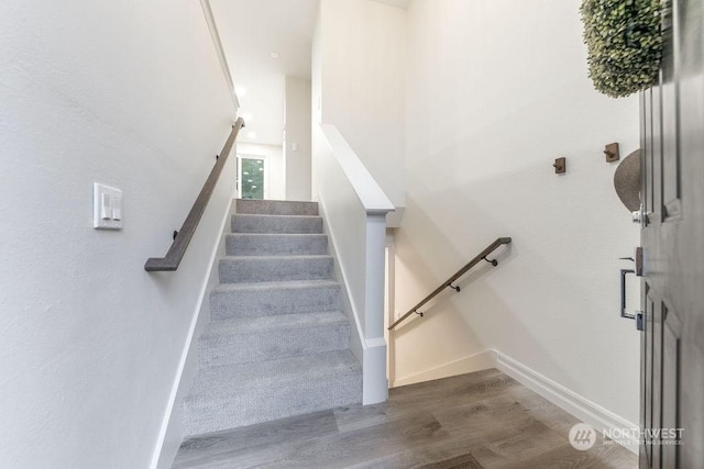 stairs featuring hardwood / wood-style floors