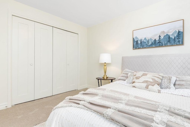 bedroom with light colored carpet and a closet