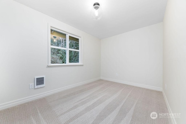 empty room featuring light colored carpet