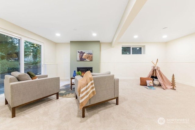 carpeted living room featuring beamed ceiling