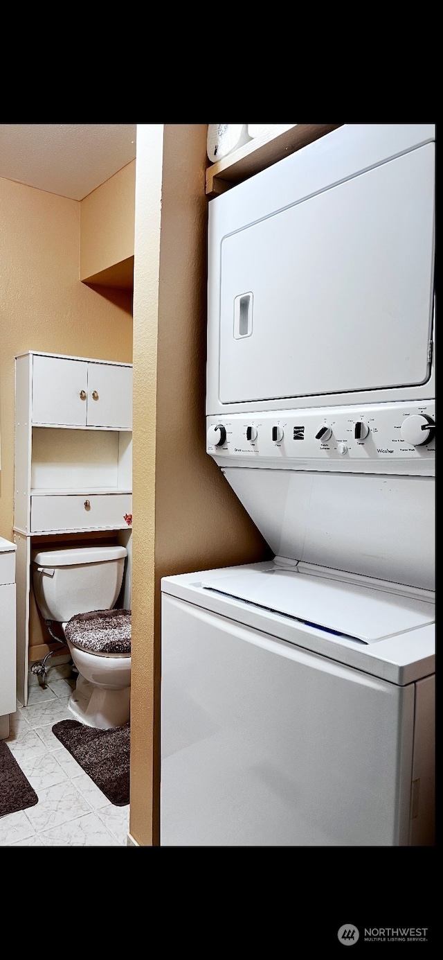 laundry area with stacked washer and dryer