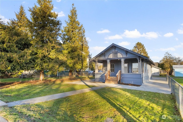 bungalow-style home featuring covered porch and a front lawn