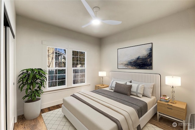 bedroom with ceiling fan and light hardwood / wood-style floors