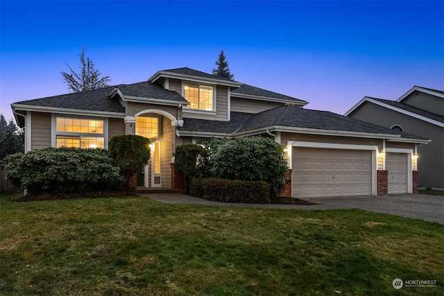 view of front of home featuring a yard and a garage