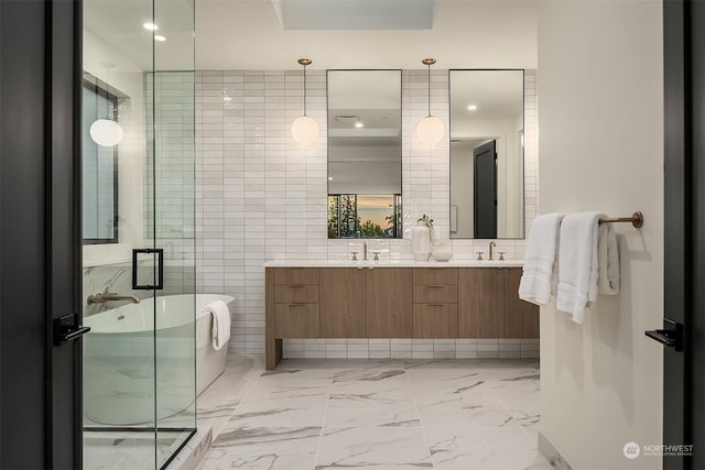 bathroom with vanity, tile walls, and shower with separate bathtub