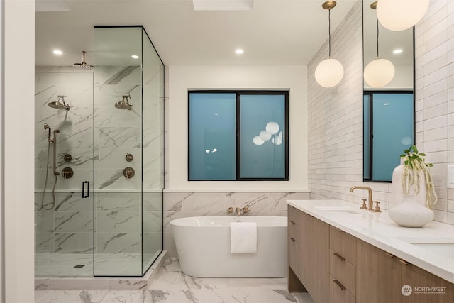 bathroom featuring vanity, separate shower and tub, and tile walls