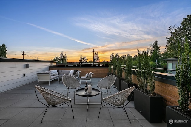 patio terrace at dusk featuring outdoor lounge area