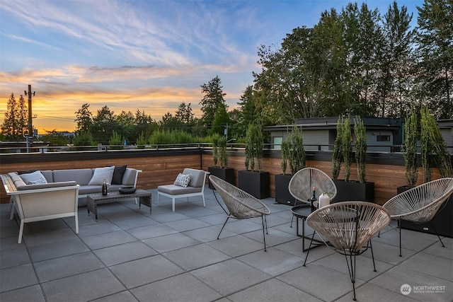 patio terrace at dusk featuring an outdoor hangout area