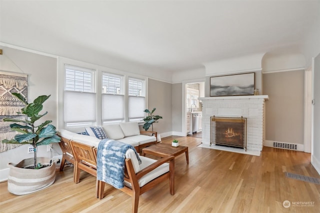 living room with wood-type flooring and a fireplace