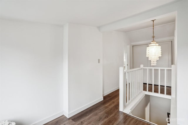 hallway featuring an inviting chandelier, dark hardwood / wood-style flooring, and vaulted ceiling with beams