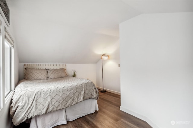 bedroom with hardwood / wood-style flooring and vaulted ceiling