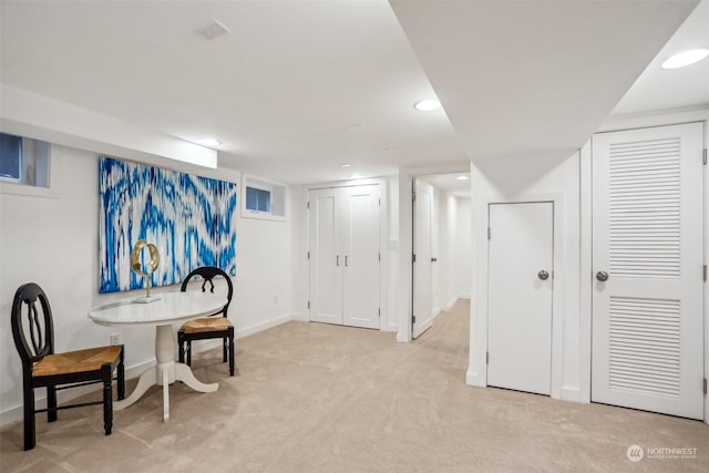 sitting room featuring light colored carpet