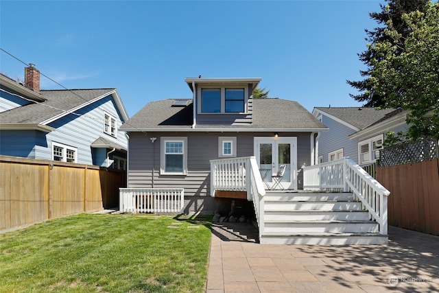 rear view of house with a patio area, a yard, and a wooden deck