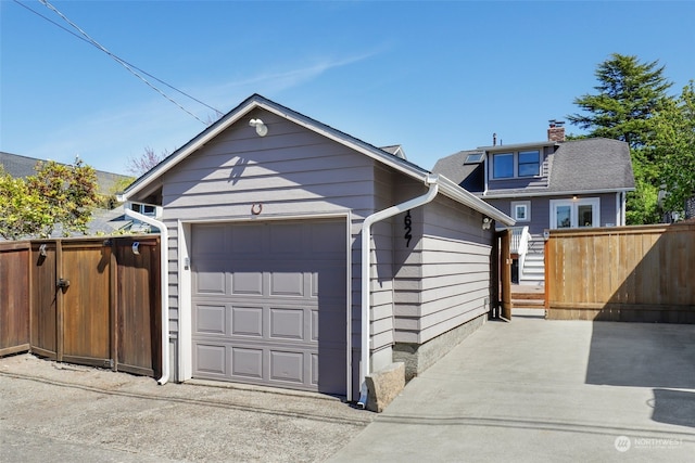 view of front of house with a garage and an outdoor structure