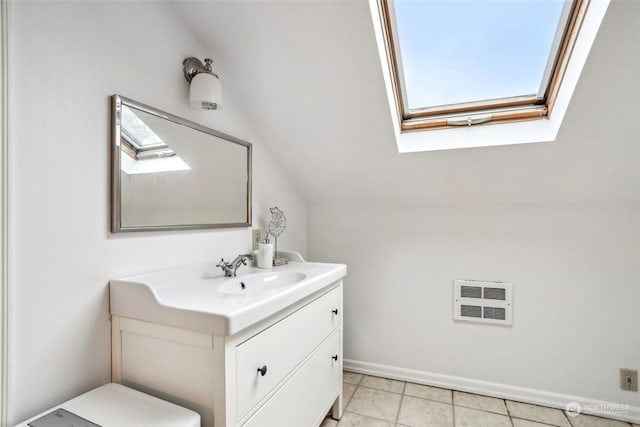 bathroom featuring vanity and lofted ceiling with skylight