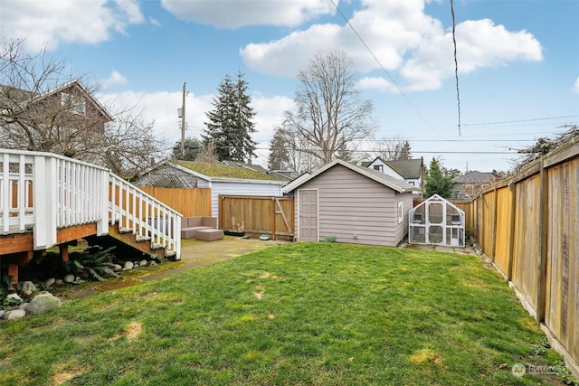 view of yard with a deck and a shed