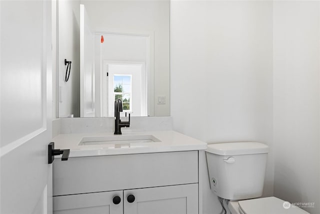 bathroom with toilet and vanity