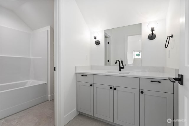 bathroom featuring vanity and lofted ceiling