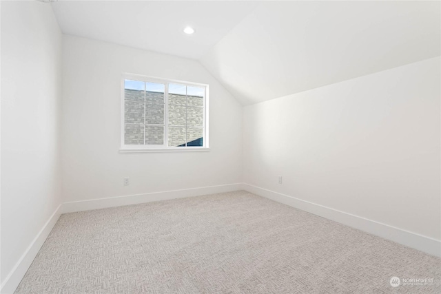 bonus room with lofted ceiling and carpet floors