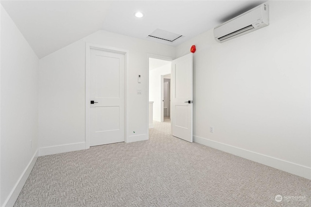 unfurnished bedroom featuring lofted ceiling, light colored carpet, and an AC wall unit