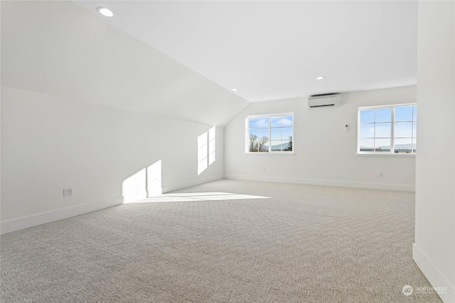 additional living space featuring an AC wall unit, light colored carpet, and vaulted ceiling