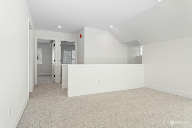 empty room featuring lofted ceiling and light colored carpet