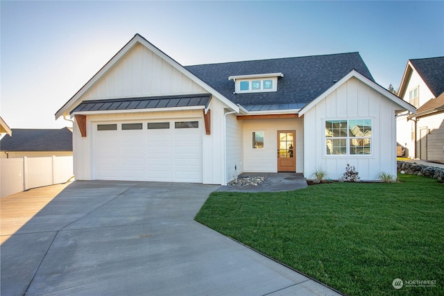 modern inspired farmhouse featuring a garage and a front lawn