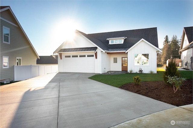 modern inspired farmhouse featuring a garage and a front lawn