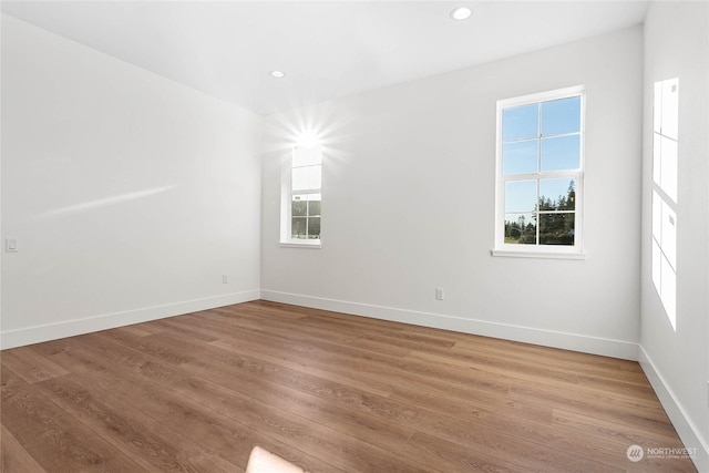 unfurnished room with hardwood / wood-style floors