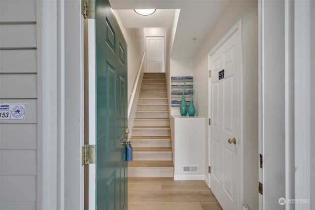 staircase with hardwood / wood-style floors