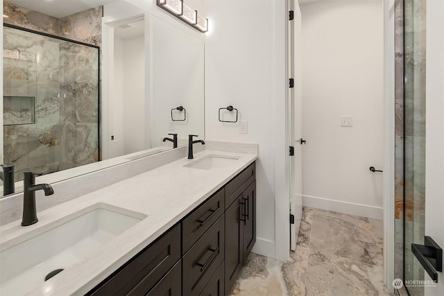 bathroom with a shower with shower door and vanity