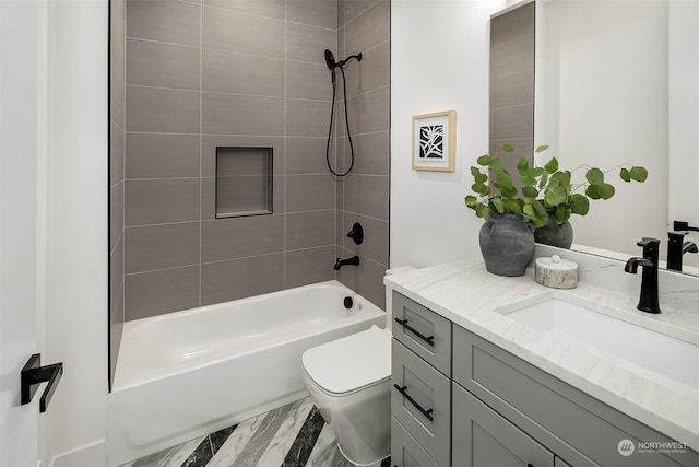 full bathroom featuring toilet, tiled shower / bath, hardwood / wood-style floors, and vanity