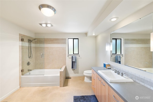 full bathroom featuring decorative backsplash, vanity, toilet, and tiled shower / bath