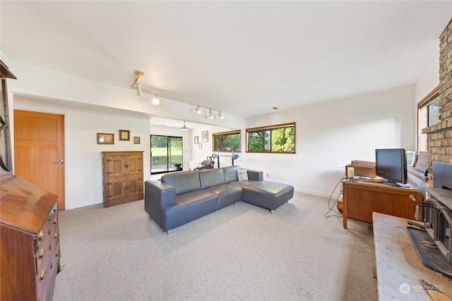 carpeted living room with rail lighting