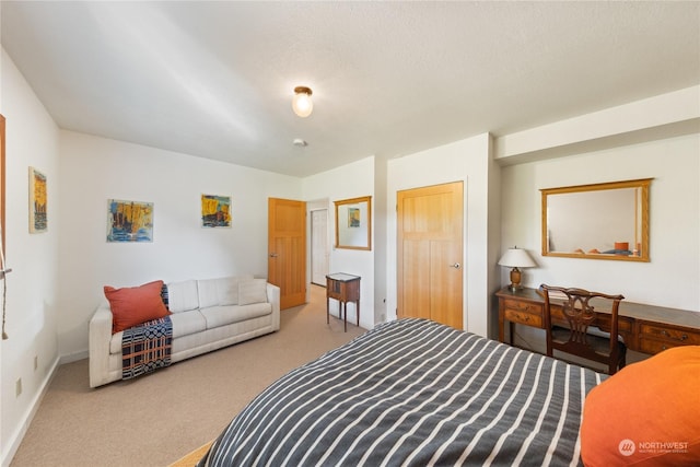 carpeted bedroom featuring a textured ceiling