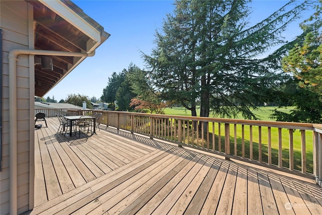 wooden deck featuring a yard