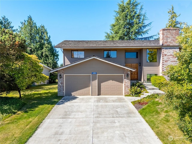 view of front of house featuring a front lawn and a garage