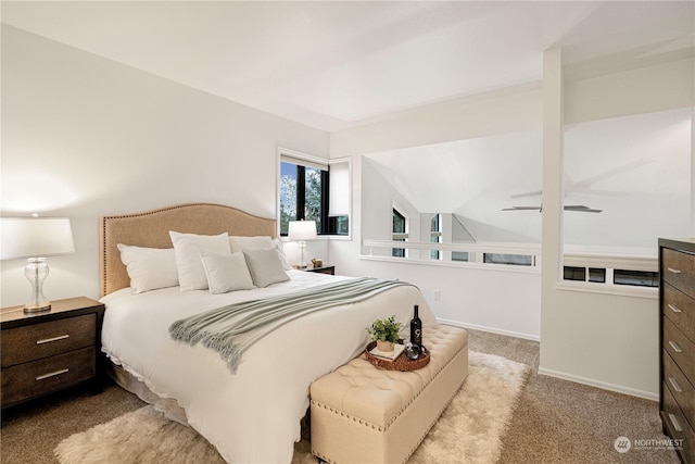 carpeted bedroom with vaulted ceiling