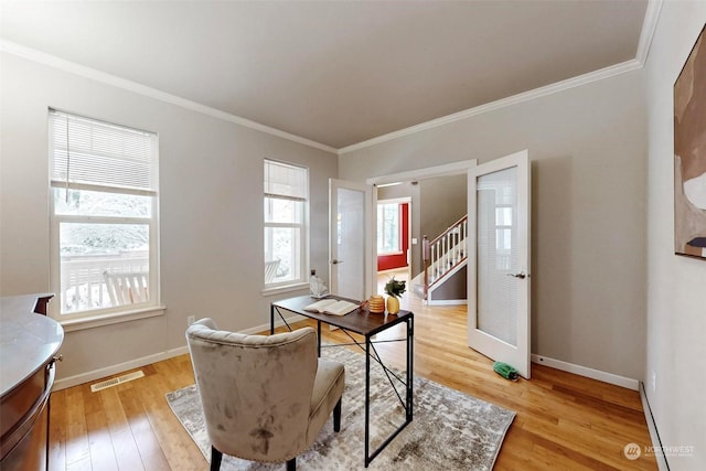 office area with light hardwood / wood-style flooring and ornamental molding