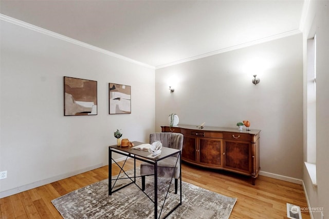 office with crown molding and light hardwood / wood-style flooring